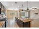 Open kitchen with island, granite countertops, and stainless steel appliances overlooking backyard at 9921 E Acceleration Dr, Mesa, AZ 85212