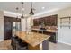 Modern kitchen featuring granite counters, an island with seating, and stainless appliances at 9921 E Acceleration Dr, Mesa, AZ 85212