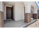 Inviting front porch area with a stylish front door and decorative pillars at 9921 E Acceleration Dr, Mesa, AZ 85212