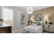 Stylish bedroom with wallpaper, soft textures, and ample natural light at 10043 S 23Rd Dr, Phoenix, AZ 85041