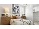 Comfortable bedroom with a decorative headboard, side tables, and an ensuite closet at 10043 S 23Rd Dr, Phoenix, AZ 85041