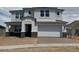 Charming two-story home features a covered entryway, a two-car garage, and neutral-toned stucco at 10043 S 23Rd Dr, Phoenix, AZ 85041