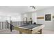 Second story game room with light colored pool table and modern light fixture at 10043 S 23Rd Dr, Phoenix, AZ 85041
