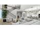 Open-concept living room and kitchen with modern decor, a staircase, and bright, neutral tones at 10043 S 23Rd Dr, Phoenix, AZ 85041