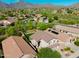 Beautiful aerial view of a desert neighborhood with homes featuring solar panels and landscaped yards at 10284 E Mallow Cir, Scottsdale, AZ 85255