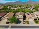 Stunning aerial view of a desert community with mountain backdrop and beautiful desert landscaping at 10284 E Mallow Cir, Scottsdale, AZ 85255