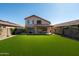Lush backyard with artificial turf, perfect for outdoor activities and easy maintenance at 10284 E Mallow Cir, Scottsdale, AZ 85255