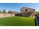Spacious backyard showcasing manicured artificial turf and a covered patio for outdoor relaxation and entertainment at 10284 E Mallow Cir, Scottsdale, AZ 85255