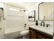Bathroom features tub with white subway tile surround, modern vanity with stone countertop at 10284 E Mallow Cir, Scottsdale, AZ 85255