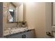 Powder room offers a granite countertop, modern sink, and vanity with stylish accents at 10284 E Mallow Cir, Scottsdale, AZ 85255