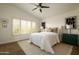 Light and airy bedroom with a vaulted ceiling, plantation shutters, neutral color scheme, and contemporary art at 10284 E Mallow Cir, Scottsdale, AZ 85255