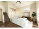 Cozy living room boasts high ceilings, neutral decor, staircase, and wood flooring at 10284 E Mallow Cir, Scottsdale, AZ 85255