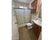 Well-lit bathroom with a shower-tub combo and wooden vanity at 11221 N 91St Dr, Peoria, AZ 85345