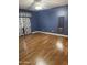Spacious bedroom featuring wood-look floors and large window at 11221 N 91St Dr, Peoria, AZ 85345