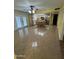 Sunlit kitchen features an island, natural wood cabinets, and stainless refrigerator at 11221 N 91St Dr, Peoria, AZ 85345