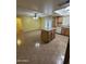 Bright kitchen featuring an island, natural wood cabinets, and tile floors at 11221 N 91St Dr, Peoria, AZ 85345