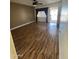 Comfortable living room with a ceiling fan and attractive light wood-look flooring at 11221 N 91St Dr, Peoria, AZ 85345