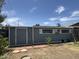 Backyard shed with multiple windows and a side entry door at 11221 N 91St Dr, Peoria, AZ 85345