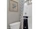 Bathroom featuring a sleek toilet, shower with glass doors and decorative wall art at 1145 E Gleneagle Dr, Chandler, AZ 85249
