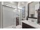 Bright bathroom featuring a glass shower and a dark vanity with a white countertop at 1145 E Gleneagle Dr, Chandler, AZ 85249