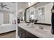 Bathroom featuring double sinks, dark wood cabinets, and access to the bedroom at 1145 E Gleneagle Dr, Chandler, AZ 85249
