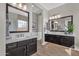 Bright bathroom featuring dual vanities and sinks, with warm wood floors at 1145 E Gleneagle Dr, Chandler, AZ 85249