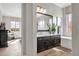 Bright bathroom featuring dual vanities and sinks, a soaking tub and warm wood floors at 1145 E Gleneagle Dr, Chandler, AZ 85249