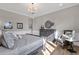 Bright bedroom with natural light, decorative dresser, chair, and warm wood floors at 1145 E Gleneagle Dr, Chandler, AZ 85249
