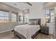 Inviting bedroom with wood-look tile floors, a cozy bed, and windows that bring in plenty of natural light at 1145 E Gleneagle Dr, Chandler, AZ 85249