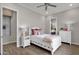 Bedroom featuring a white wooden bed frame, wood-look tile floors, and ample natural light at 1145 E Gleneagle Dr, Chandler, AZ 85249