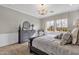 Inviting bedroom featuring a decorative dresser and chair, with natural light from a large window at 1145 E Gleneagle Dr, Chandler, AZ 85249
