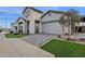 Charming single-Gathering home featuring a gray brick exterior, manicured lawn and driveway at 1145 E Gleneagle Dr, Chandler, AZ 85249
