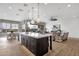 Open-concept kitchen with large island, stainless appliances, and stylish pendant lighting at 1145 E Gleneagle Dr, Chandler, AZ 85249