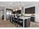 Kitchen featuring large island with seating, stainless steel appliances and modern pendant lights at 1145 E Gleneagle Dr, Chandler, AZ 85249