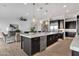 Spacious kitchen with central island featuring stainless steel appliances and dark wood cabinets at 1145 E Gleneagle Dr, Chandler, AZ 85249