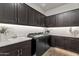 Functional laundry room featuring modern appliances, cabinetry and countertops at 1145 E Gleneagle Dr, Chandler, AZ 85249