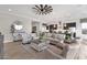 Open concept living area with ceiling fan, hardwood floors, and view to the kitchen at 1145 E Gleneagle Dr, Chandler, AZ 85249