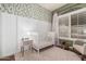 Cozy Bedroom with a crib, accent wall, and window with natural light at 1161 N Cole Dr, Gilbert, AZ 85234