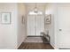 Welcoming foyer featuring a stylish light fixture, decorative wall art, and tile flooring at 1161 N Cole Dr, Gilbert, AZ 85234
