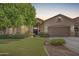 Home featuring a well-manicured front yard and a two car garage at 1161 N Cole Dr, Gilbert, AZ 85234