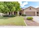 Charming home featuring a well-manicured front yard with lush landscaping at 1161 N Cole Dr, Gilbert, AZ 85234