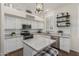 Well-lit kitchen with white cabinets and stainless steel appliances at 1161 N Cole Dr, Gilbert, AZ 85234