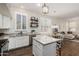 Modern kitchen with white cabinets, granite countertops, and stainless steel appliances at 1161 N Cole Dr, Gilbert, AZ 85234
