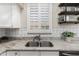 Close-up of a kitchen sink with white cabinets and granite countertops at 1161 N Cole Dr, Gilbert, AZ 85234