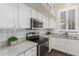 White kitchen cabinets with stainless steel appliances and granite countertops at 1161 N Cole Dr, Gilbert, AZ 85234
