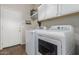 Laundry room featuring appliances, storage cabinets and a door to the outside at 1161 N Cole Dr, Gilbert, AZ 85234