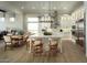 Bright, open-concept kitchen with stainless steel appliances, pendant lighting, a spacious island, and ample cabinet space at 1180 E Peach Tree Dr, Chandler, AZ 85249