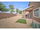 Low maintenance backyard with a covered patio, rock ground cover, and block fence at 12022 W Belmont W Dr, Avondale, AZ 85323