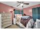 Bedroom featuring a bed, dresser, ceiling fan, and curtains at 12022 W Belmont W Dr, Avondale, AZ 85323
