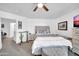 Bright bedroom with a queen bed, gray carpet, and ample natural light at 12022 W Belmont W Dr, Avondale, AZ 85323